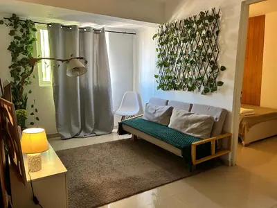 a living room with a couch and a chair at Central 1-Bedroom Apartment near Sucupira Market in Praia