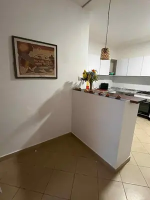 a kitchen with a counter with a picture on the wall at Casa Minuxa in Santa Maria