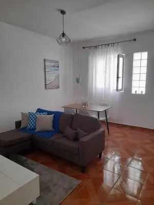 a living room with a couch and a table at Tarrafal snuggle in Tarrafal
