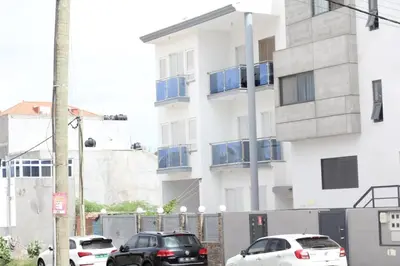 two cars parked in front of a building at Rooms in Apartment Morabeza in Praia Cidadela in Praia