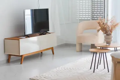 a living room with a tv and a chair at Rooms in Apartment Morabeza in Praia Cidadela in Praia
