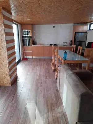 a living room with a table and a kitchen at Apartamento Borges in Praia