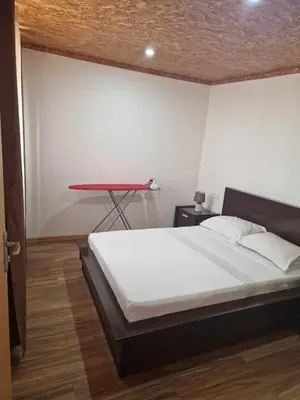a bedroom with a bed and a red table at Apartamento Borges in Praia