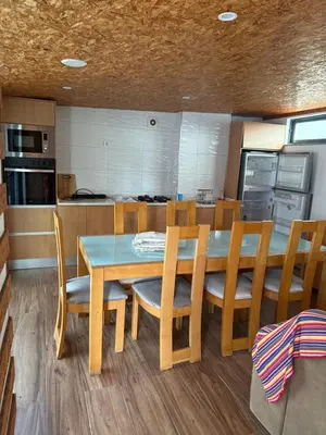 a kitchen with a dining room table and chairs at Apartamento Borges in Praia