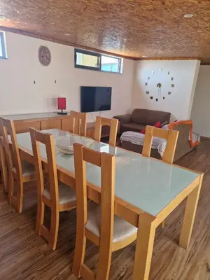 a dining room and living room with a table and chairs at Apartamento Borges in Praia