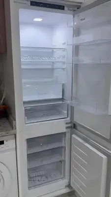 an empty refrigerator with its door open in a kitchen at Apartamento Cidade in Mindelo