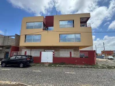 a building with a car parked in front of it at Paz, Tranquilidade e Conforto in Espargos