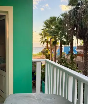 a balcony with a view of the beach and palm trees at Estrela Mar - Wi-Fi included in Santa Maria