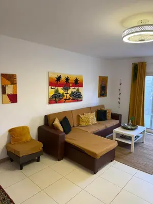 a living room with a couch and a table at Vila Verde TownHouse T53 by RPG Group in Santa Maria