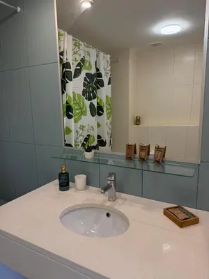 a bathroom with a sink and a mirror at Vila Verde TownHouse T53 by RPG Group in Santa Maria