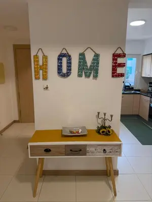 a desk in a room with the word mom on the wall at Vila Verde TownHouse T53 by RPG Group in Santa Maria