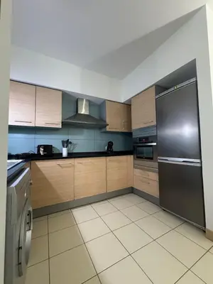 a kitchen with a stainless steel refrigerator and cabinets at Vila Verde Lantana B103 by RPG Group in Santa Maria