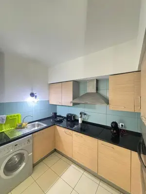 a kitchen with a sink and a washing machine at Vila Verde Lantana B103 by RPG Group in Santa Maria