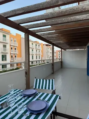 a table and chairs on a balcony with a view at Vila Verde Lantana B103 by RPG Group in Santa Maria