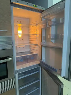 an empty refrigerator with its door open in a kitchen at Vila Verde Lantana B103 by RPG Group in Santa Maria