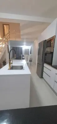 a white kitchen with a sink and a stove at Apartamento Duplex Boa Vista in Sal Rei