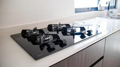 a kitchen counter with a black stove top oven at Domus Lima in Mindelo