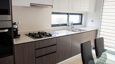 a kitchen with a stove and a sink at Domus Lima in Mindelo