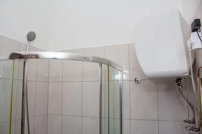 a shower with a glass door in a bathroom at T1 Mindelo City Center in Mindelo