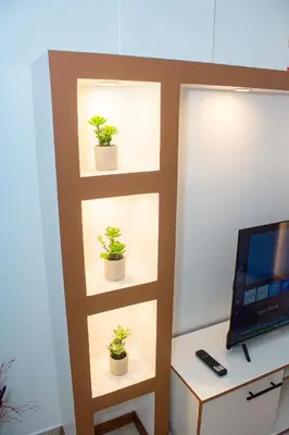 a shelf with potted plants in a room at T1 Mindelo City Center in Mindelo