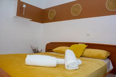 a bed with towels and pillows on it at T1 Mindelo City Center in Mindelo