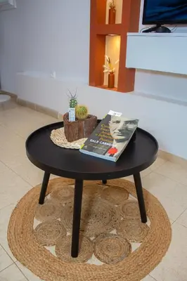 a black table with a book and a magazine on it at Studio City Center in Mindelo