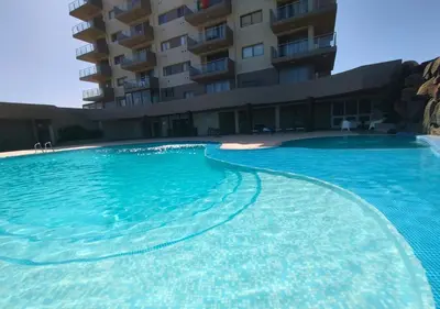 a large swimming pool in front of a building at MonteCara View T1 in Mindelo