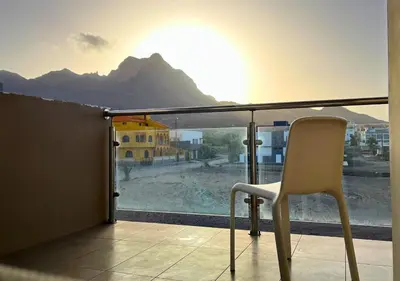 a chair sitting on a balcony with a view of a mountain at MonteCara View T1 in Mindelo
