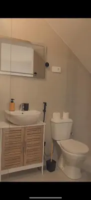 a bathroom with a toilet and a sink at Castro AP in Mindelo