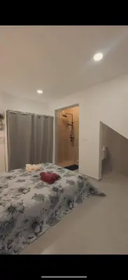 a bedroom with a bed and a bathroom with a shower at Castro AP in Mindelo