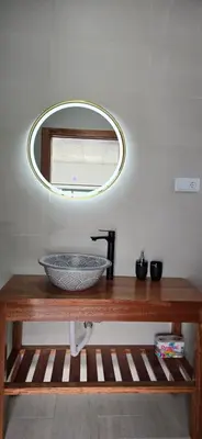 a bathroom with a bowl on a wooden table with a mirror at The Pink Banana in Paul