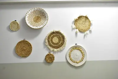 a display of gold and white plates on a wall at Cozy Palm in Praia