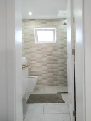 a bathroom with a tub and a toilet and a window at Lamore 01 - more comfortable of all in Beirona