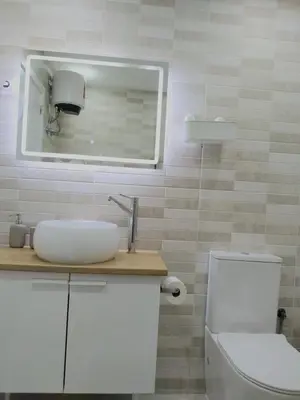 a bathroom with a toilet and a sink and a mirror at Lamore 01 - more comfortable of all in Beirona