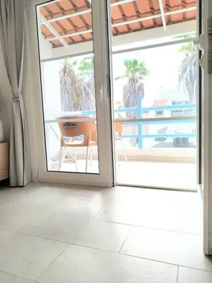 an open door to a patio with a view of the ocean at Lamore 01 - more comfortable of all in Beirona