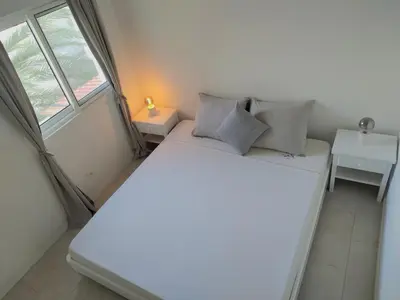 a white bed in a room with a window at Lamore 01 - more comfortable of all in Beirona