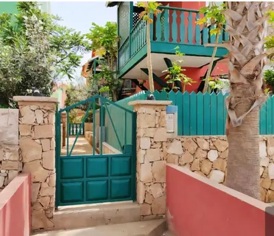 an entrance to a house with a green gate at Ibiscus Penthouse in Santa Maria