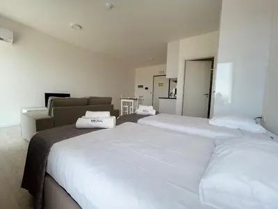 a bedroom with two beds and a couch at Apartamento T0 - MedSal Residence in Prainha