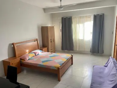 a bedroom with a bed and a window at T0 Brisa Tropical in Sal Rei
