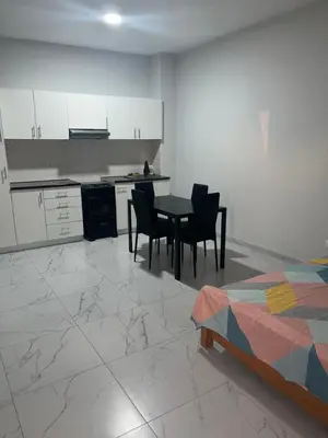 a kitchen and dining room with a table and chairs at T0 Brisa Tropical in Sal Rei