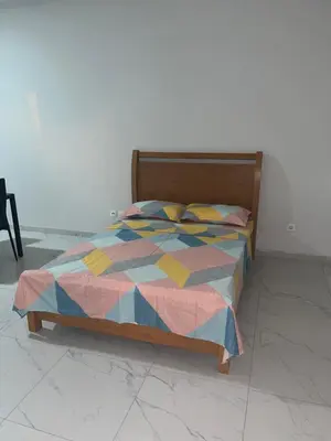 a bed with a colorful comforter in a room at T0 Brisa Tropical in Sal Rei