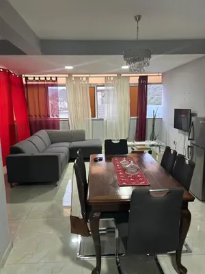 a living room with a table and a couch at CasaTanha in Mindelo