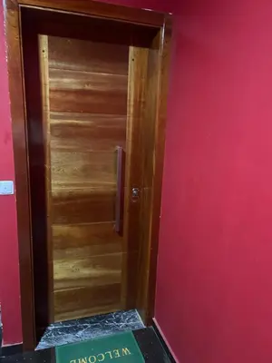 a wooden door in a room with a pink wall at CasaTanha in Mindelo