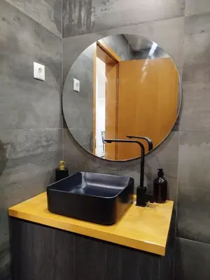a bathroom with a black sink and a mirror at Empire Home! in Praia