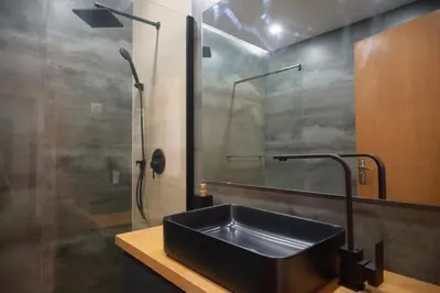 a bathroom with a black sink and a shower at Empire Home! in Praia