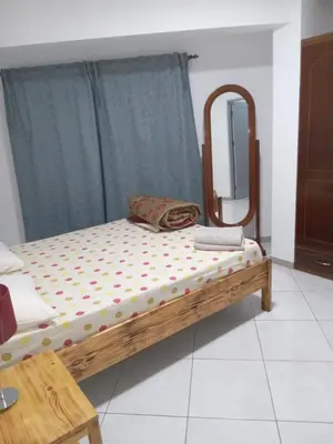 a bed with a mirror in a room at T3 Mindelo in Mindelo