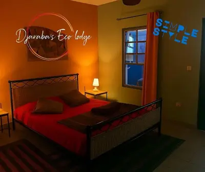 a bedroom with a bed with red sheets and a window at Djabraba's kaminhu Double in Vila Nova Sintra
