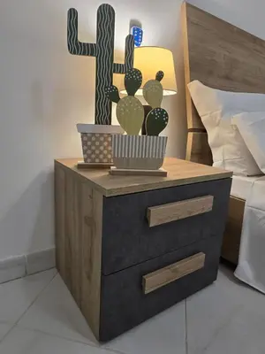 a cactus and a cross on a nightstand next to a bed at Soul of Sal in Santa Maria