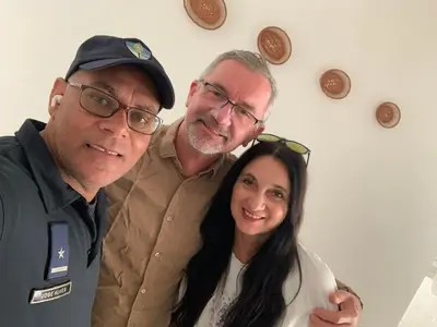 two men and a woman posing for a picture at MONTROND House in São Filipe