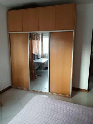 a large wooden cabinet with a mirror in a room at Gada House in Sal Rei